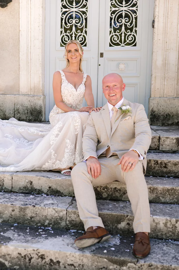 Bride and Groom on steps of French Chateau captured by Sophie Last Photography, wedding photographer Towcester UK