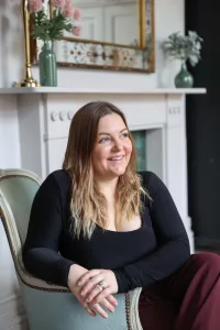 Sophie Last sitting in a comfy chair looking into the room